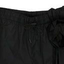 BLACK TECH NYLON WITH ANKLE GATHERING AND PRESSED ROSE TRACK TROUSERS